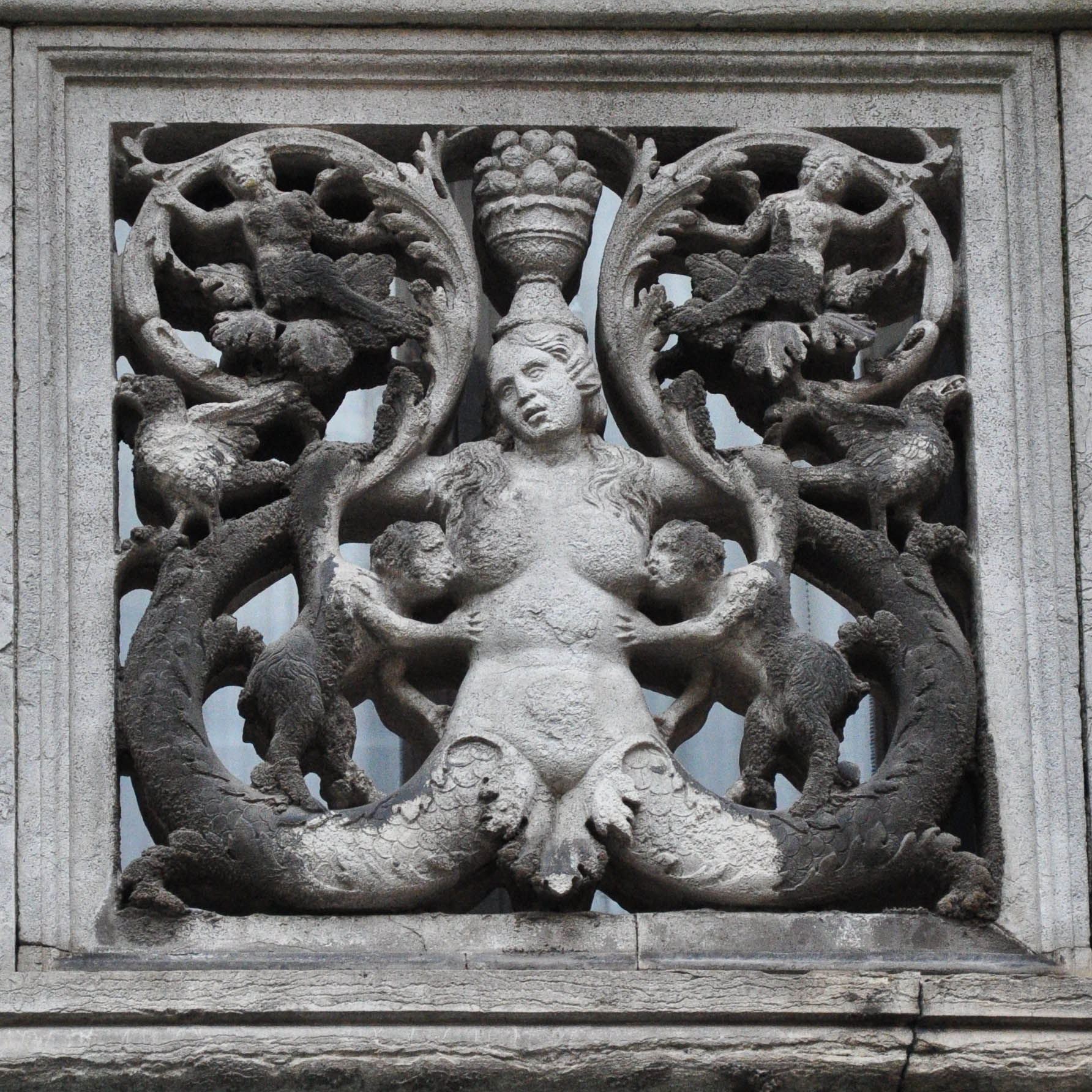 A close-up of a balcony with a brestfeeding bas-relief, Venice, Italy