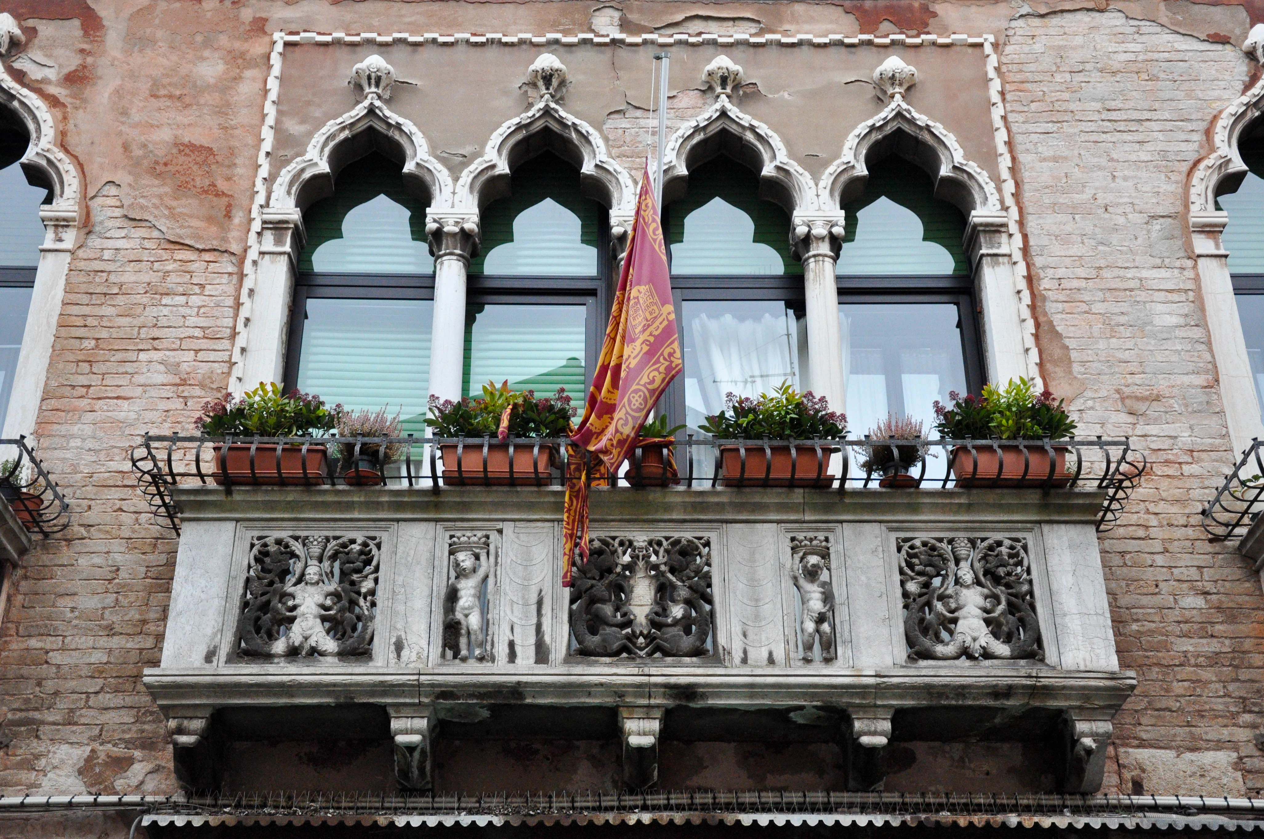 Balcony with a brestfeeding bas-relief, Venice, Italy