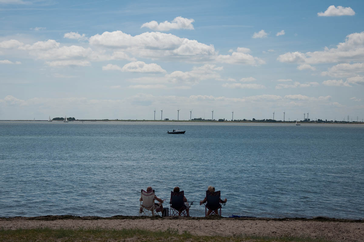 Sitting on foldable chairs at the beach, Mersea Island, Essex, England - www.rossiwrites.com