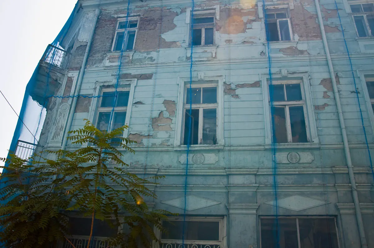 dilapidated-light-blue-house-covered-with-a-protective-net-varna-bulgaria-www.rossiwrites.com