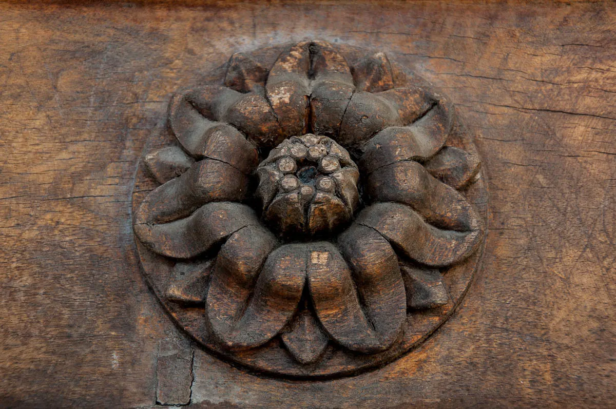 A close-up of a flower carved out of wood on the main gate of the Tempio Canoviano or the Temple of Canova - Possagno, Treviso, Veneto, Italy - www.rossiwrites.com