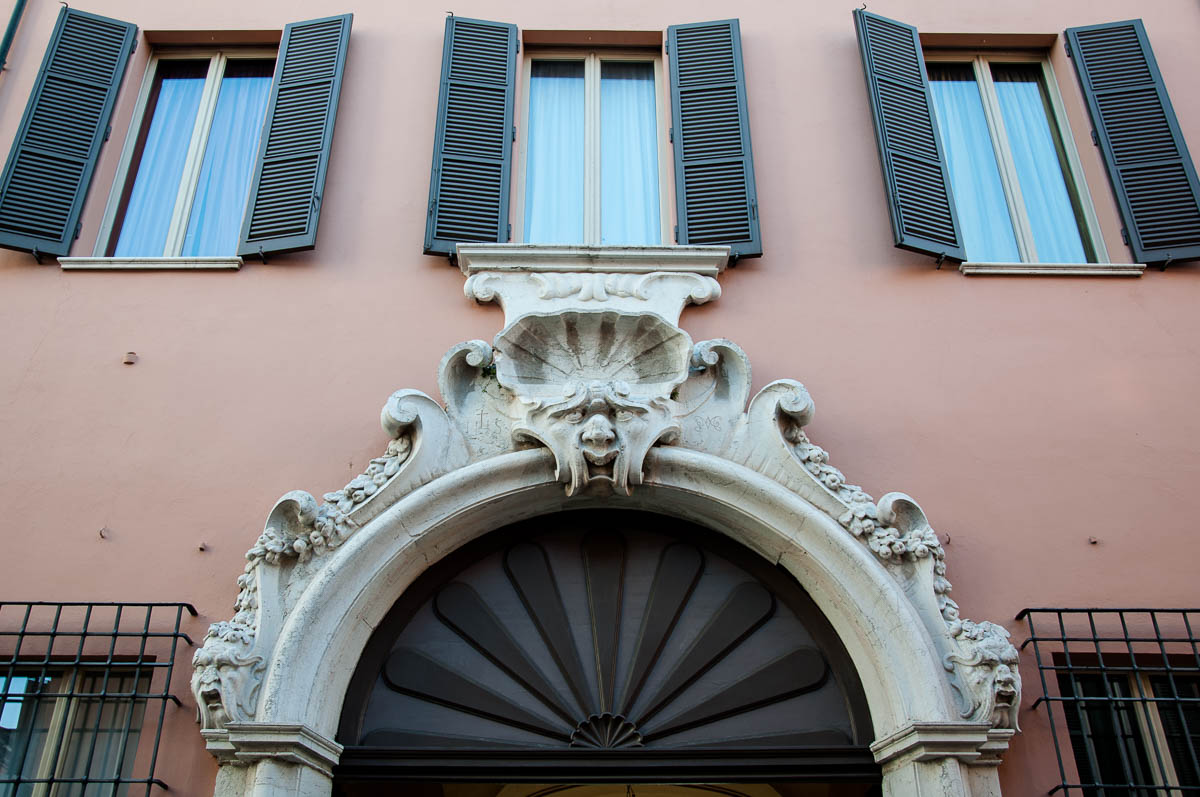 A grotesque face adorning the gate of a large house - Ravenna, Emilia Romagna, Italy - www.rossiwrites.com