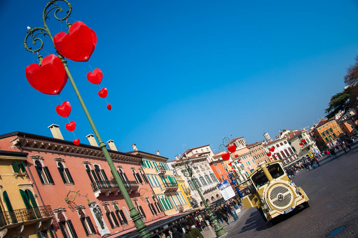 Piazza Bra decorated with hearts and a tourist sightseeing train - Verona, Italy - www.rossiwrites.com