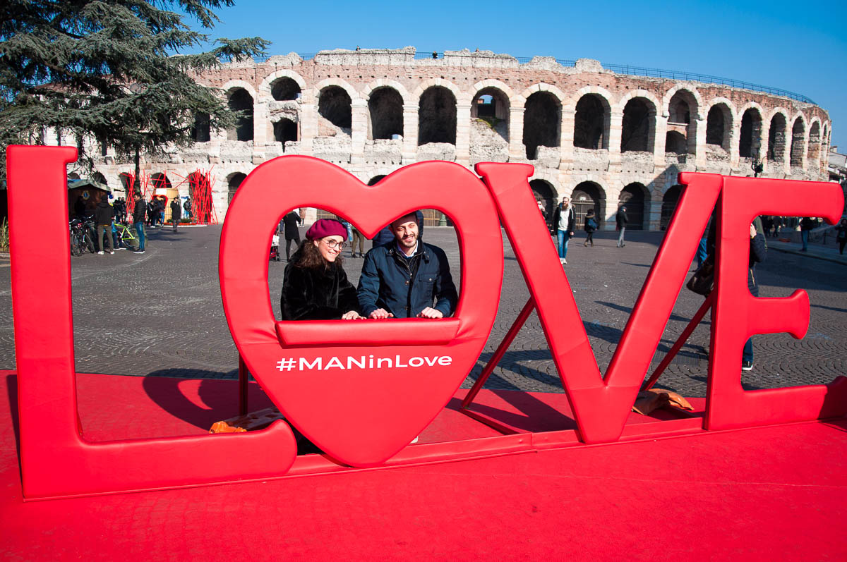 Arena di Verona with a big LOVE sign and a couple in love - Verona, Italy - www.rossiwrites.com