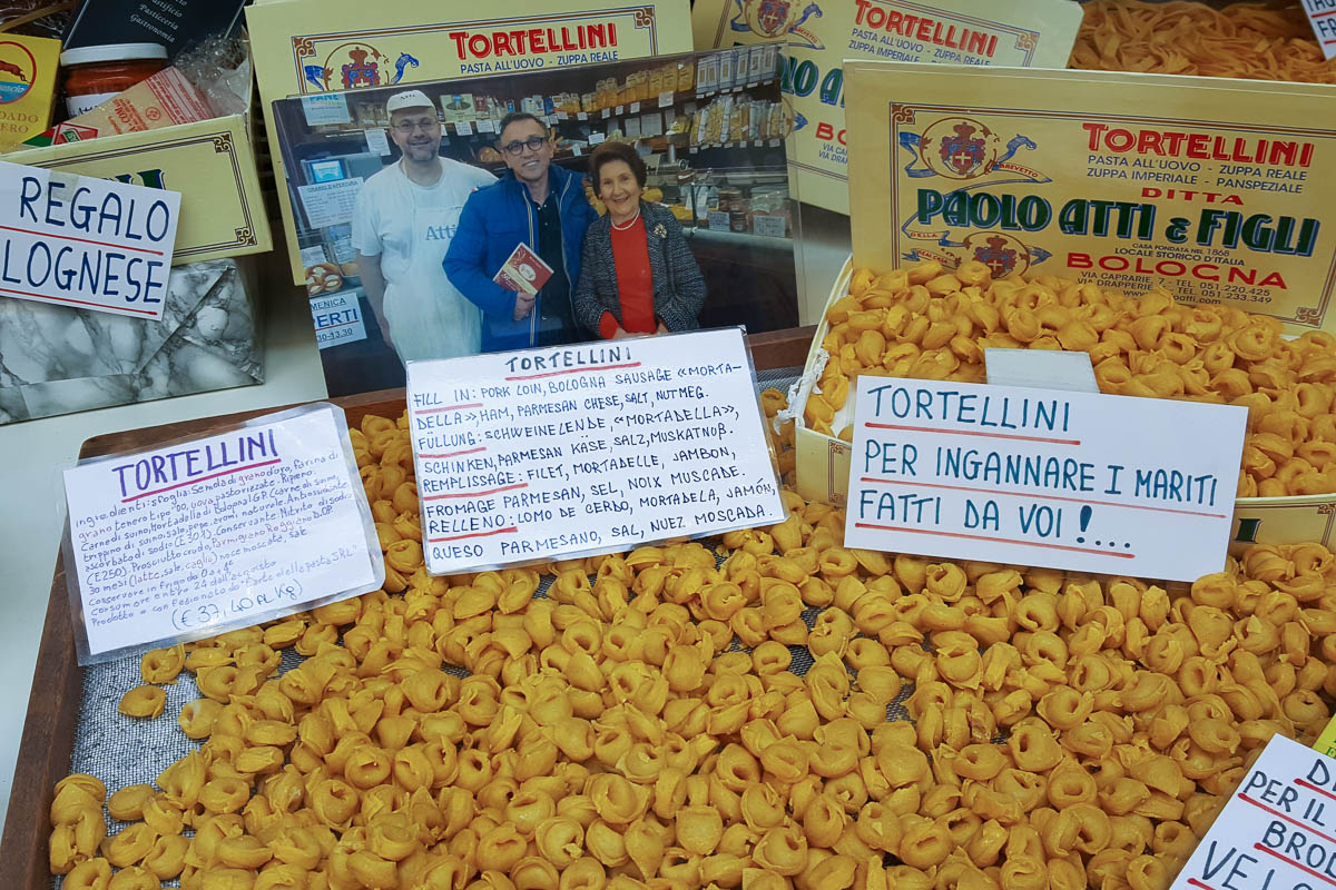 Window display with torta di riso and other local specialties - Bologna, Emilia-Romagna, Italy - www.rossiwrites.com