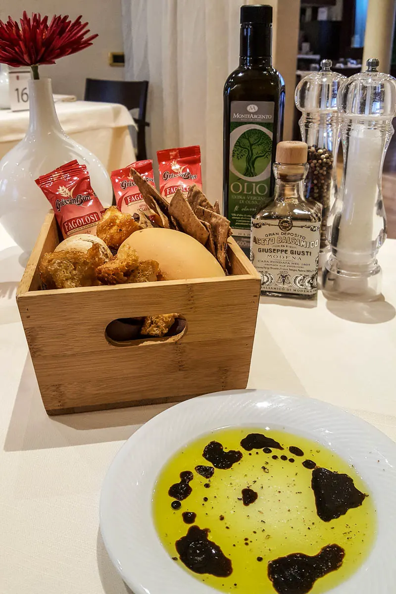 A bread basket with a plate with olive oil and balsamic vinegar - Restaurante Mezzaluna - Hotel Viest, Vicenza, Italy - www.rossiwrites.com