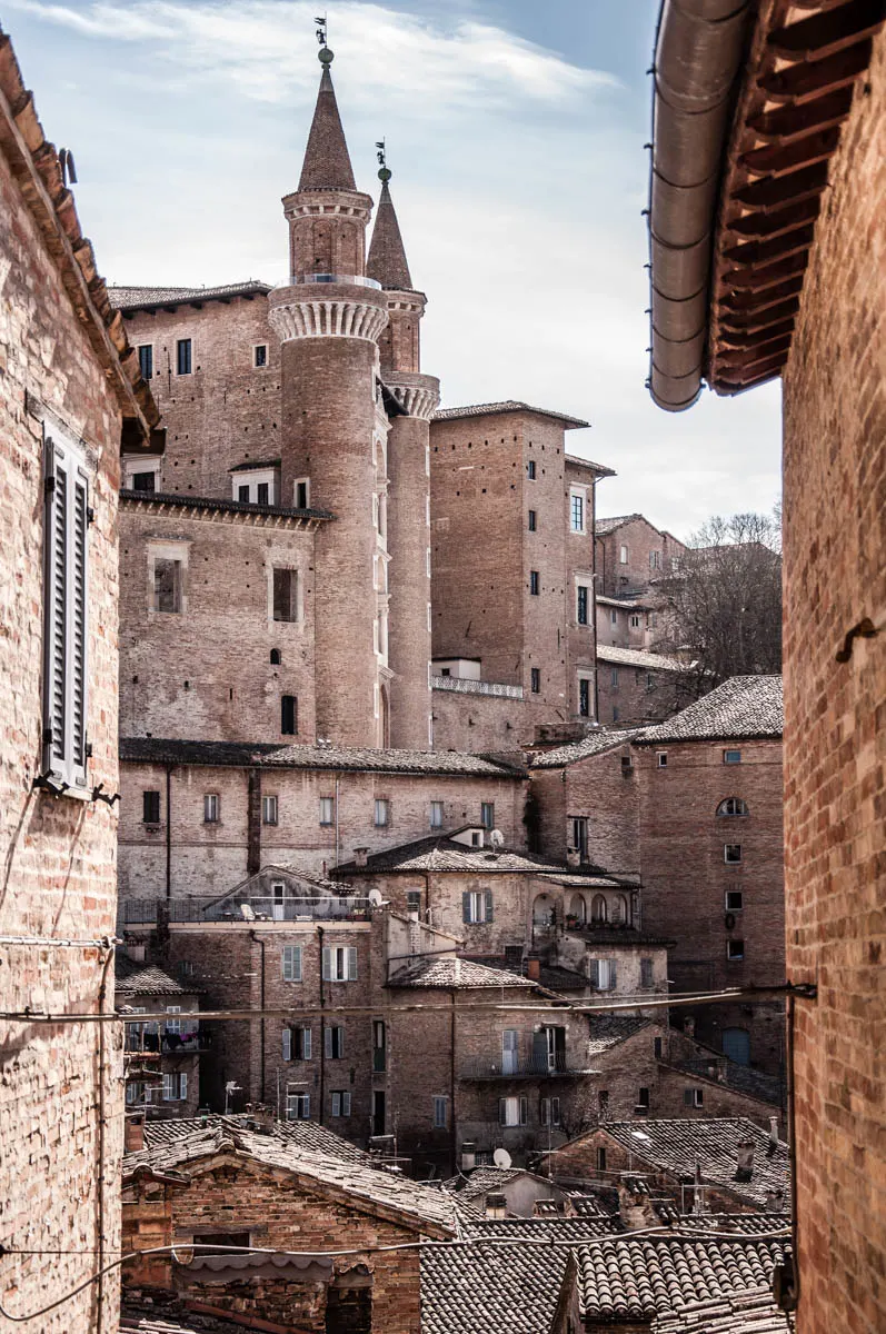 The Ducal Palace with rooftops - Urbino, Marche, Italy - www.rossiwrites.com