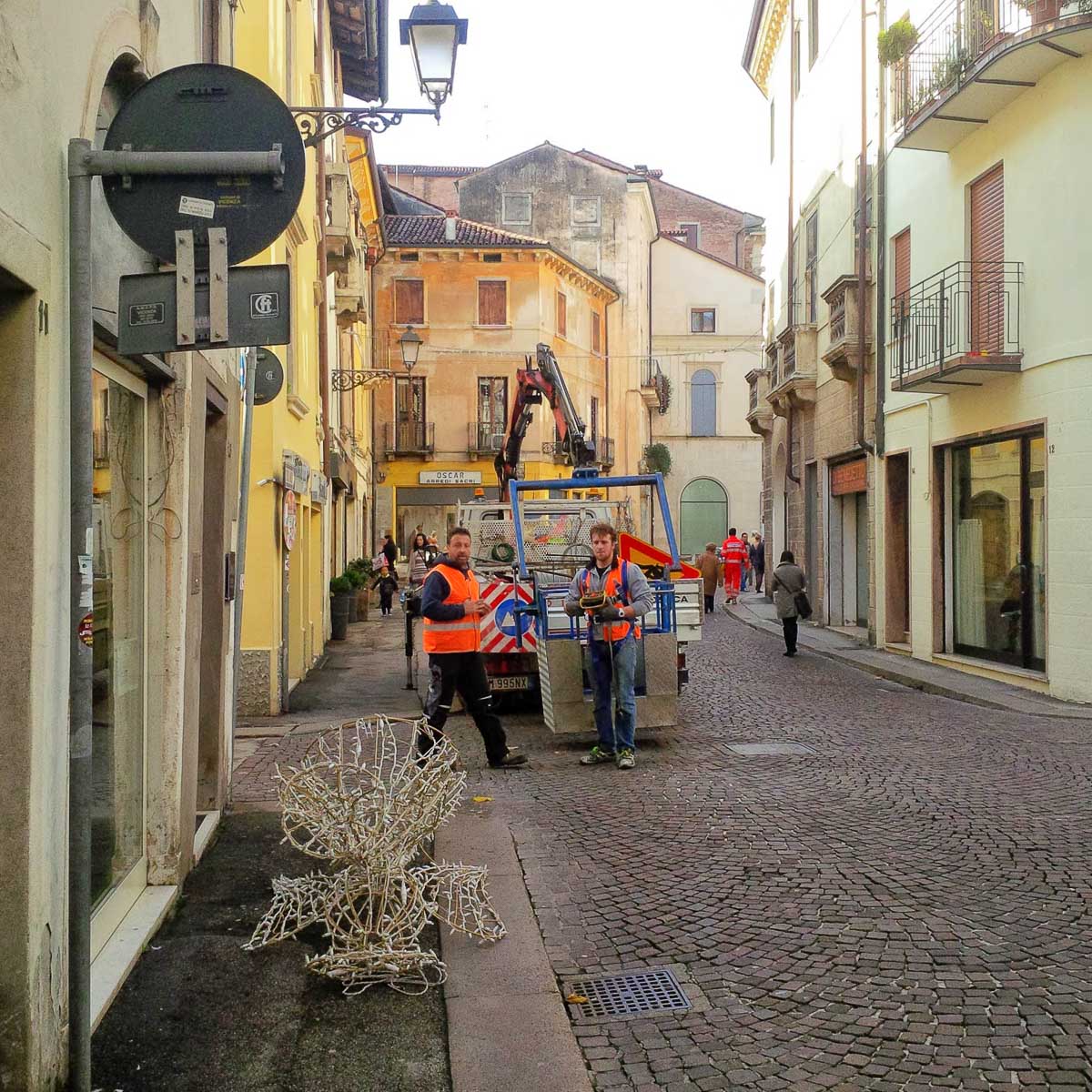 Workers hanging Christmas decorations in the historic centre - Vicenza, Italy - rossiwrites.com