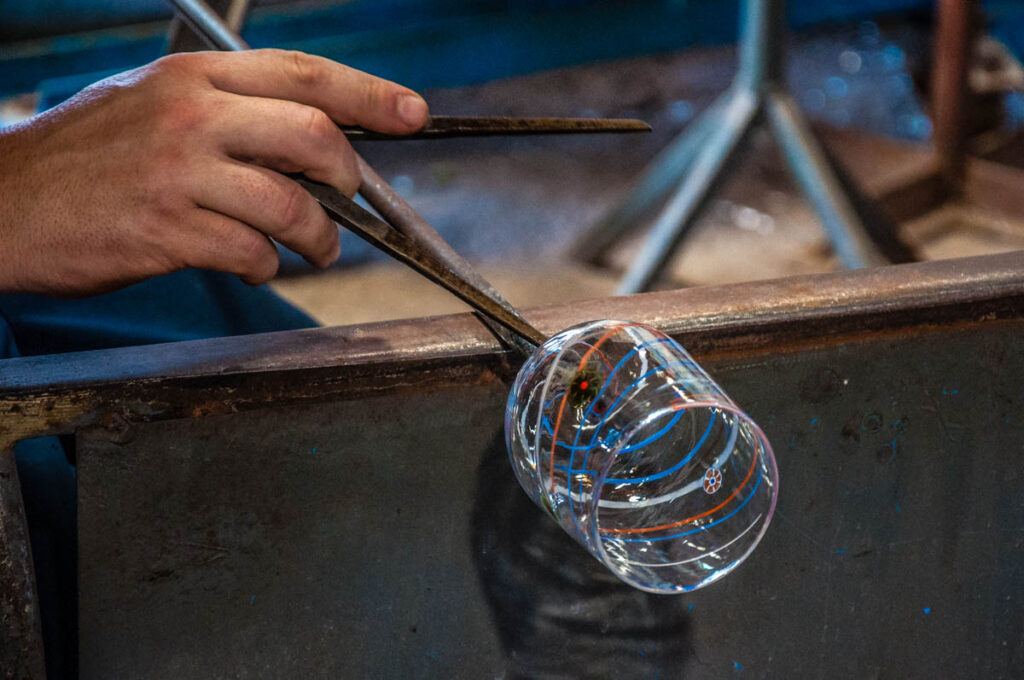 A glassmaker making a glass by hand - Murano, Italy - rossiwrites.com
