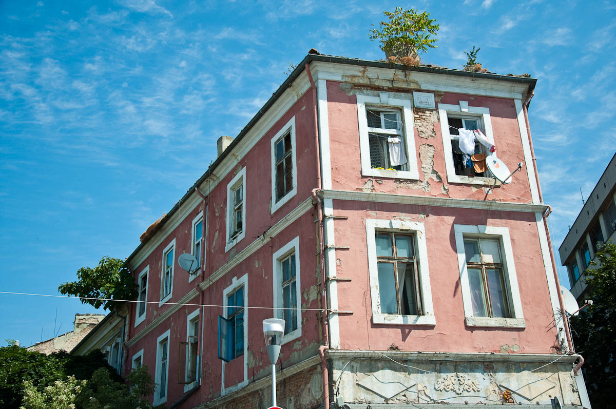 a-dilapidated-pink-house-with-trees-growing-on-its-roof-varna-bulgaria-www.rossiwrites.com