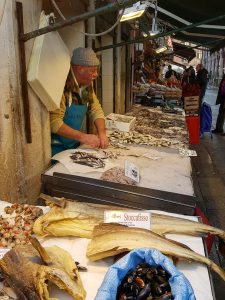A fishmonger at work - Rialto Fish Market, Venice, Italy - www.rossiwrites.com