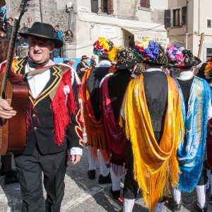 Men in traditional dress with long colourful scarves - Bagolino, Lombardy, Italy - www.rossiwrites.com