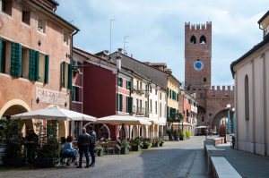 The high street with a preserved medieval tower and gate - Noale, Veneto, Italy - www.rossiwrites.com