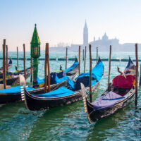 Gondolas with the island of San Giorgio Maggiore in the background - Venice, Italy - www.rossiwrites.com