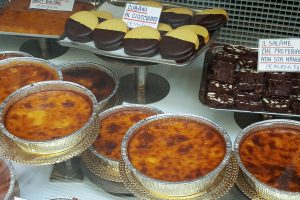 Window display with torta di riso and other local specialties - Bologna, Emilia-Romagna, Italy - www.rossiwrites.com