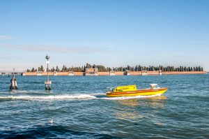 A Venetian ambulance boat with Isola di San Michele at the back - Venice, Veneto, Italy - www.rossiwrites.com