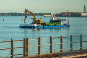 A digger on a platform in the Venetian lagoon - Venice, Veneto, Italy - www.rossiwrites.com