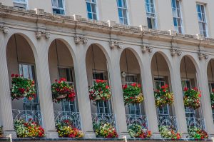 A facade dripping with flowers in bloom - Cheltenham, England - www.rossiwrites.com