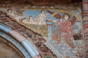 A faded fresco of the Last Judgement above the entrance of the Church of Santi Felice e Fortunato - Vicenza, Italy - www.rossiwrites.com