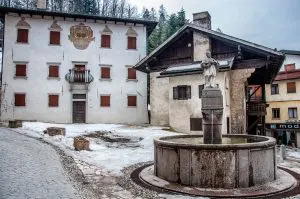 Side view of Titian's birth house with a fountain and a 16th century palace - Pieve di Cadore - Province of Belluno, Veneto, Italy - www.rossiwrites.com