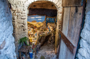 An open door and steps leading to an intricate Nativity Scene - Campo di Brenzone, Lake Garda, Italy - www.rossiwrites.com