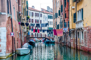 View of a canal with houses and clotheslines - Venice, Italy - www.rossiwrites.com