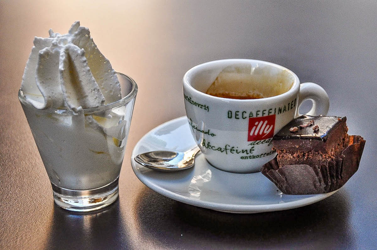 Decaffeinated espresso with whipped cream and a bite-size cake - Vicenza, Italy - rossiwrites.com