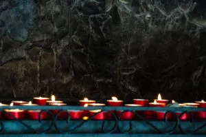 Lit candles - Sanctuary of Madonna della Corona - Spiazzi, Veneto, Italy - rossiwrites.com