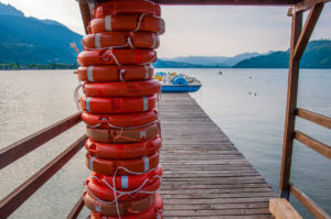 A view of Lake Caldonazzo with lifebuoys and a boardwalk - Trentino, Italy - rossiwrites.com