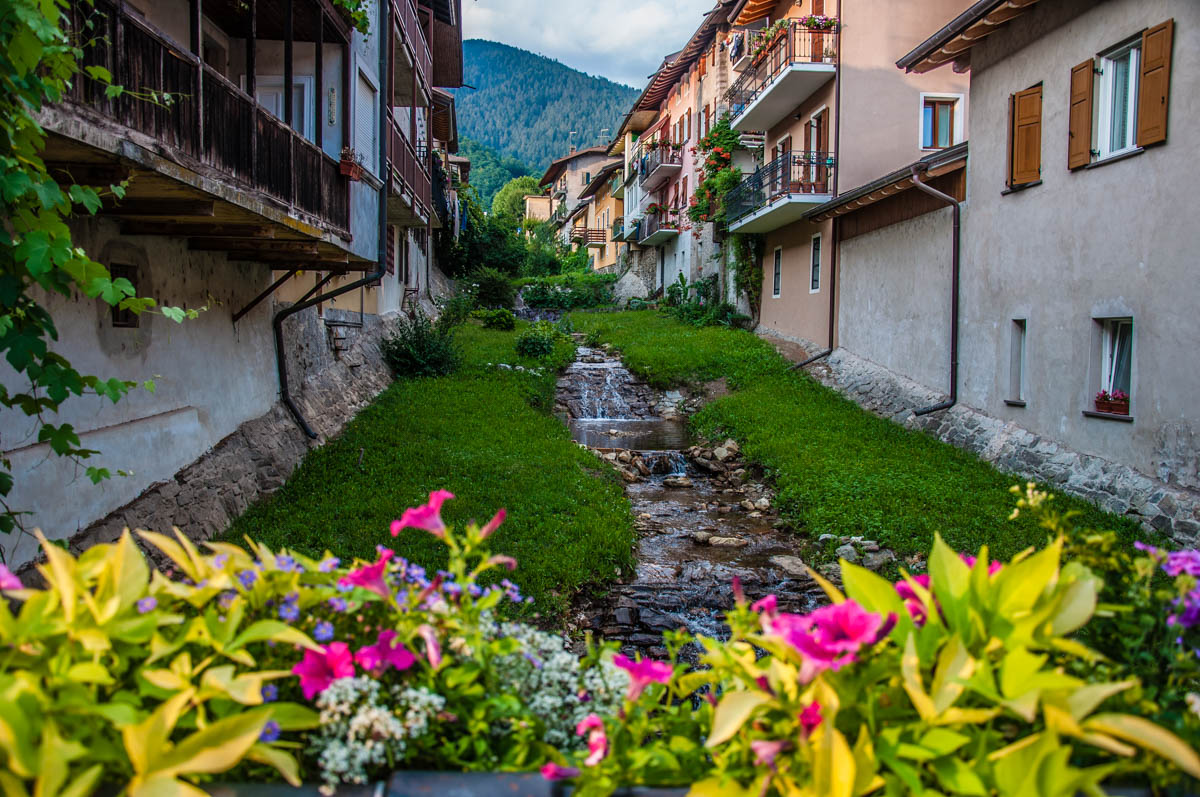 View of Levico Terme with flowers and a stream - Valsugana, Trentino, Italy - rossiwrites.com