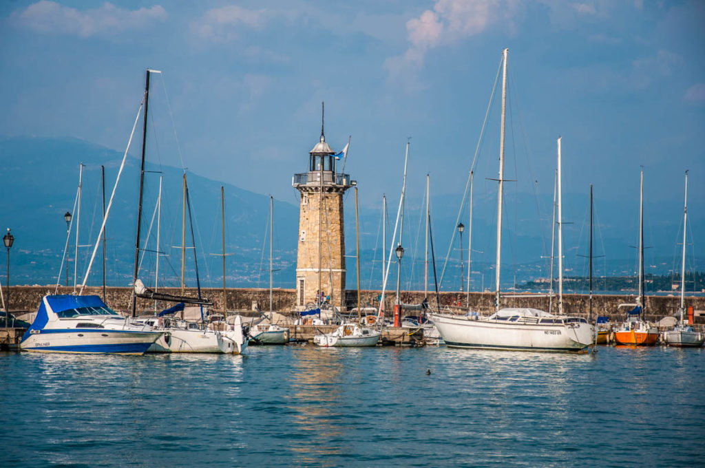 View of Lake Garda with boats and a lighthouse - Desenzano del Garda - Lombardy, Italy - rossiwrites.com