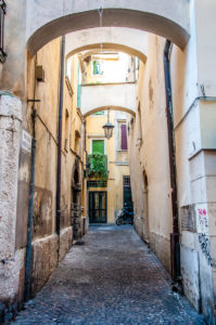 Side street with arches and a motorbike - Verona, Veneto, Italy - rossiwrites.com
