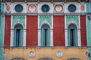 A beautiful facade in red, green and yellow - Montagnana, Veneto, Italy - rossiwrites.com