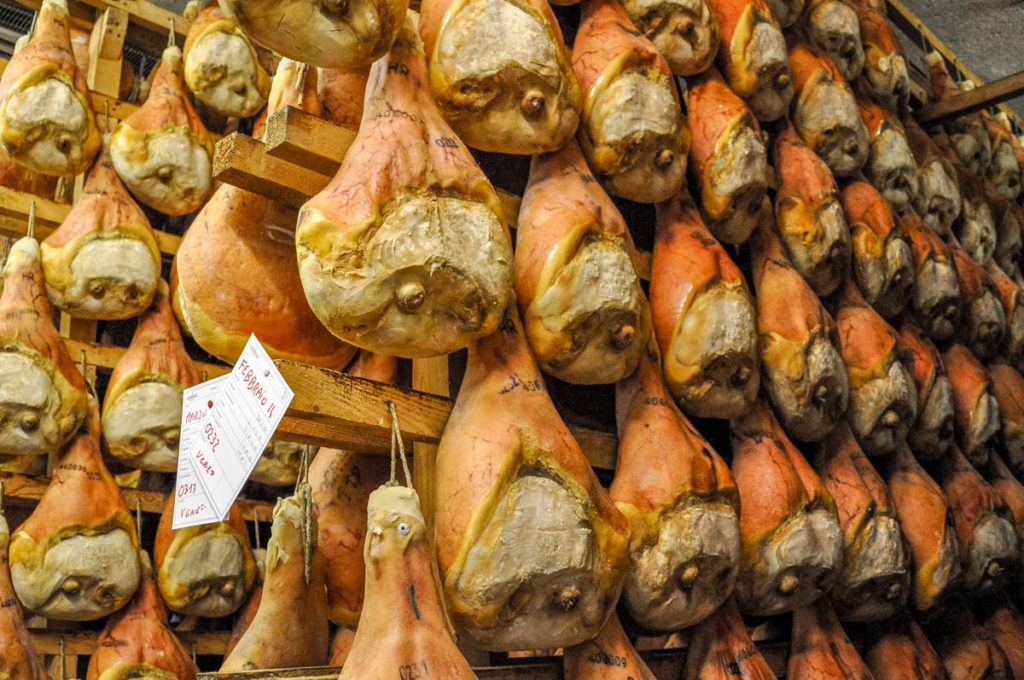 Rows of prosciutto hams being dry cured the traditional way - Montagnana, Veneto, Italy - rossiwrites.com