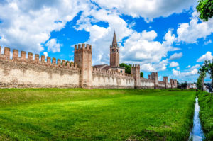 The medieval defensive wall with the Church of San Francesco and the grassy moat - Montagnana, Veneto, Italy - rossiwrites.com