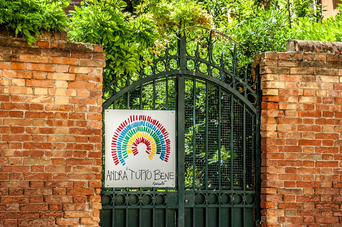 Gate with an Andra Tutto Bene poster - Venice, Italy - rossiwrites.com