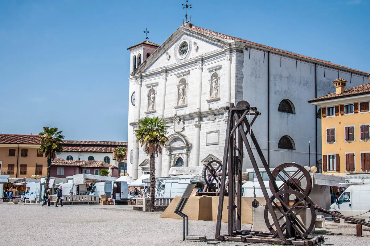 Replicas of old machines with the Church of the Santissimo Redentore - Palmanova, Friuli-Venezia Giulia, Italy - www.rossiwrites.com