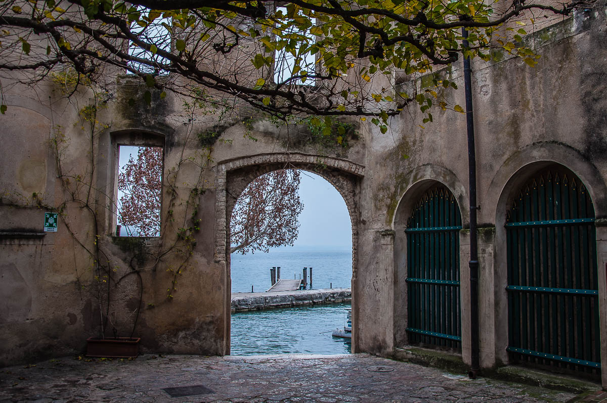 The arched gateway leading to the small harbour - Punta di San Vigilio - Lake Garda, Italy - rossiwrites.com