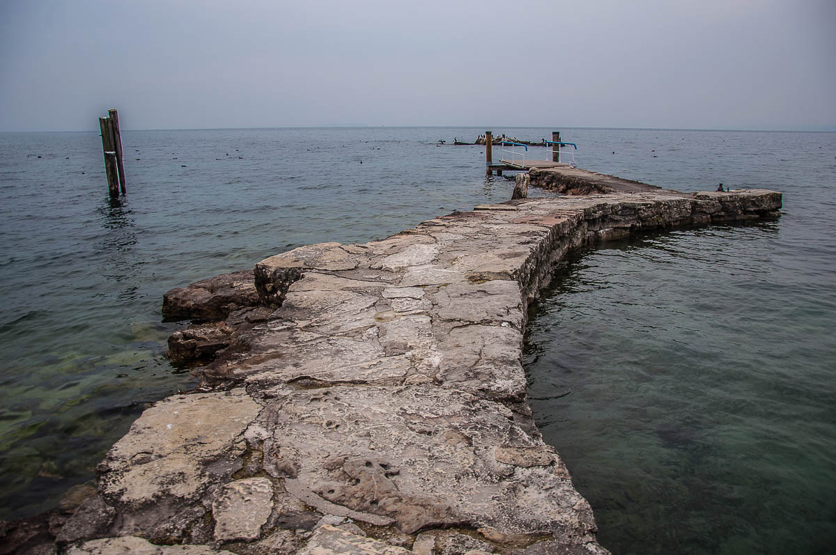 The stone jetty of the small harbour - Punta di San Vigilio - Lake Garda, Italy - rossiwrites.com