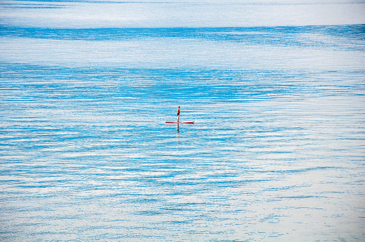 A person on a paddleboard on Lake Garda - Torri del Benaco, Italy - rossiwrites.com