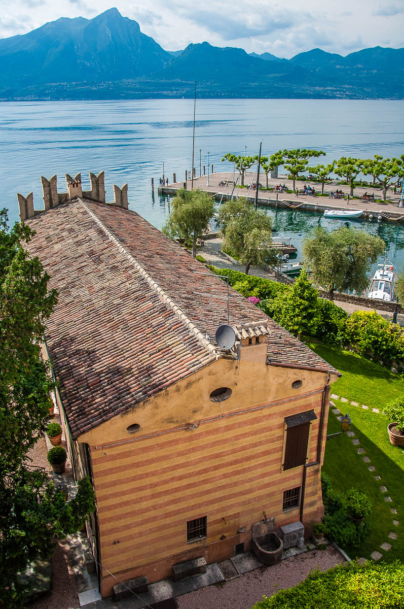 The view from the battlements of the Scaliger Castle with the historic harbour - Torri del Benaco, Italy - rossiwrites.com