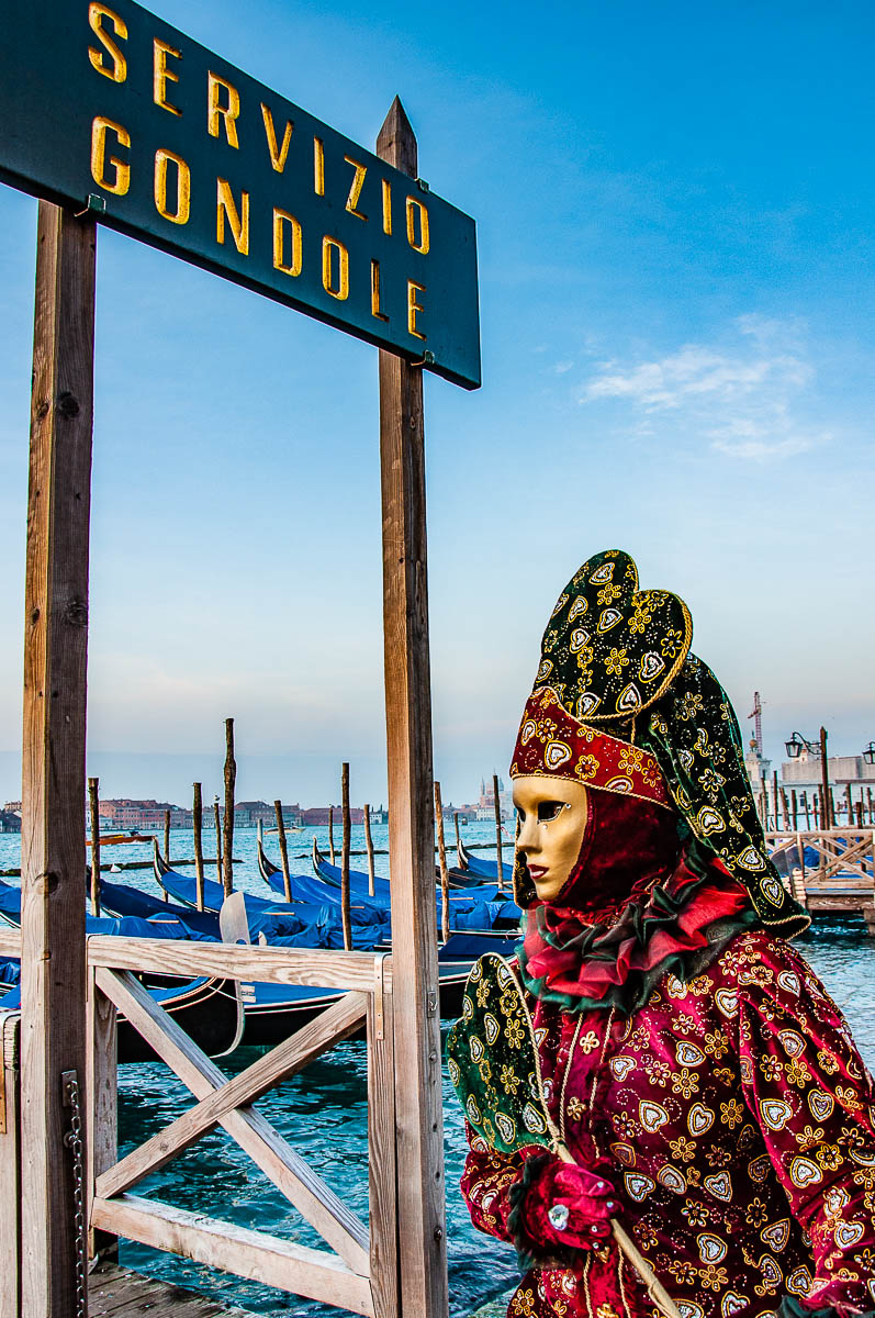 A beautiful Venetian mask standing next to the gondola service stand - Venice, Italy - rossiwrites.com