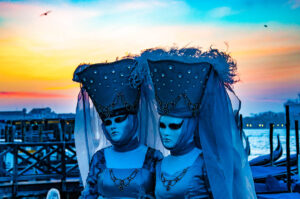 Two beautiful Venetian masks under an orange dawn - Venice, Italy - rossiwrites.com