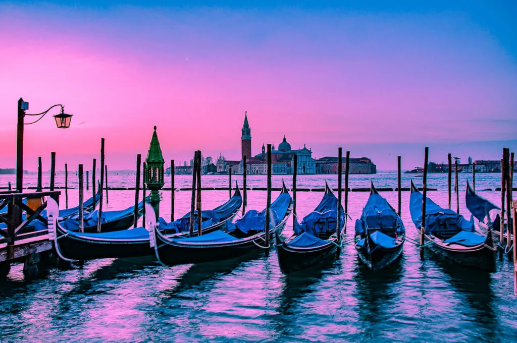 Venetian gondolas and the island of San Giorgio Maggiore under a purple dawn - Venice, Italy - rossiwrites.com