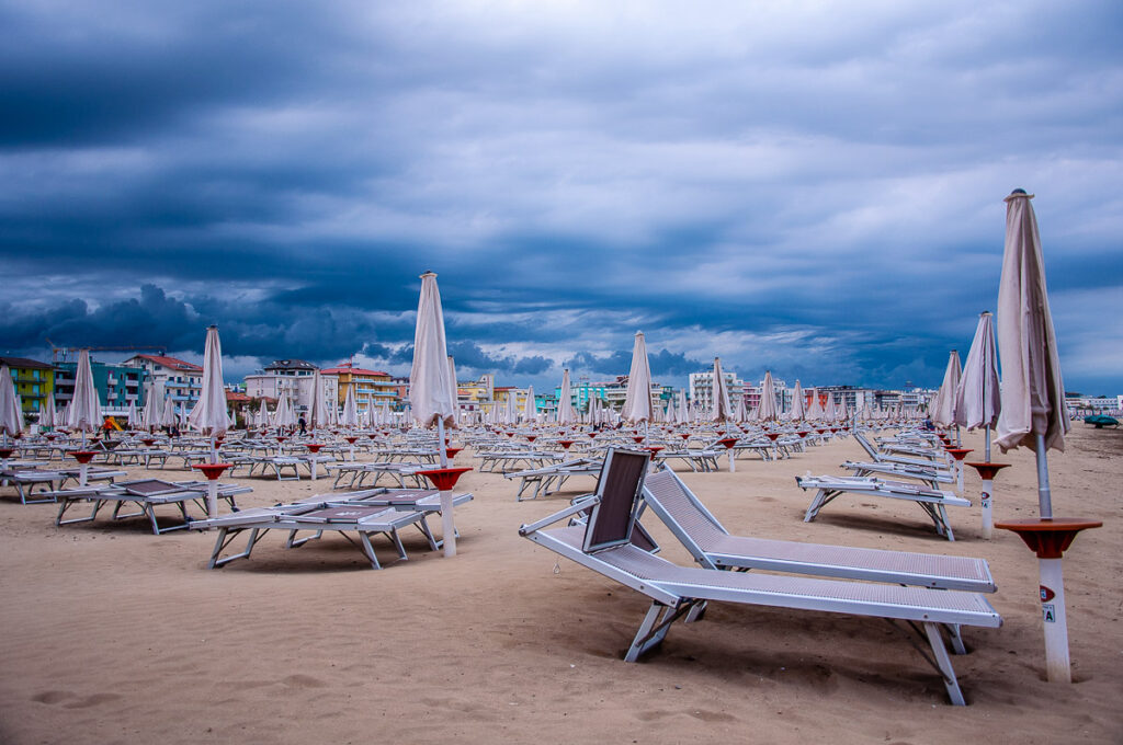 A huge sandy beach lined up by colourful hotels - Caorle, Italy - rossiwrites.com