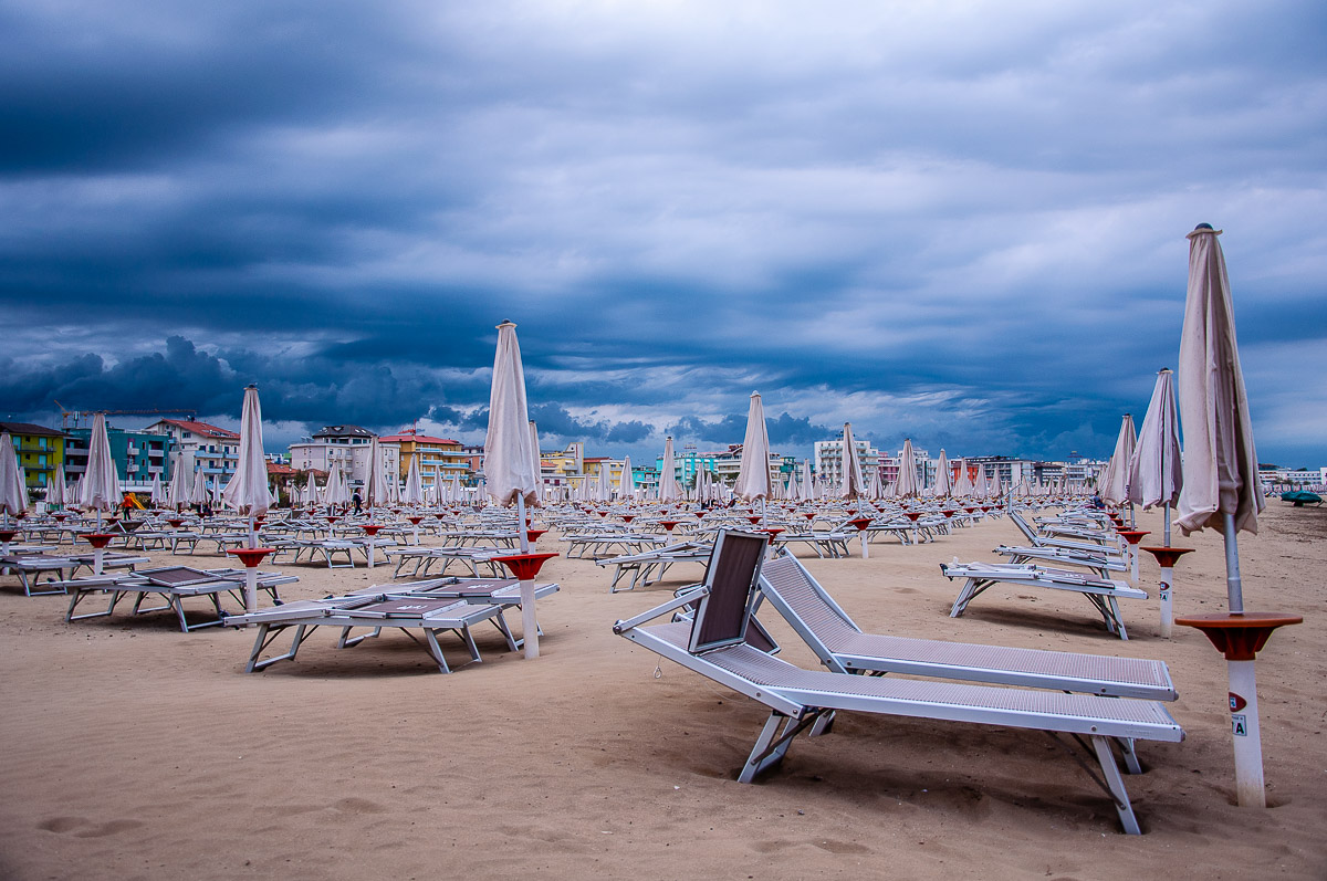 A huge sandy beach lined up by colourful hotels - Caorle, Italy - rossiwrites.com