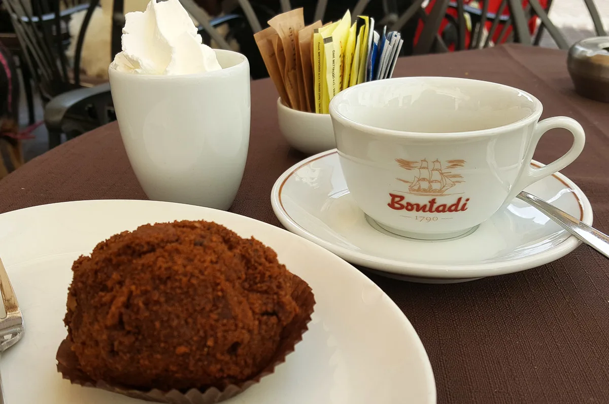 Cup of espresso with whipped cream and a chocolate truffle served at the historic caffe Bontadi - Rovereto, Italy - rossiwrites.com