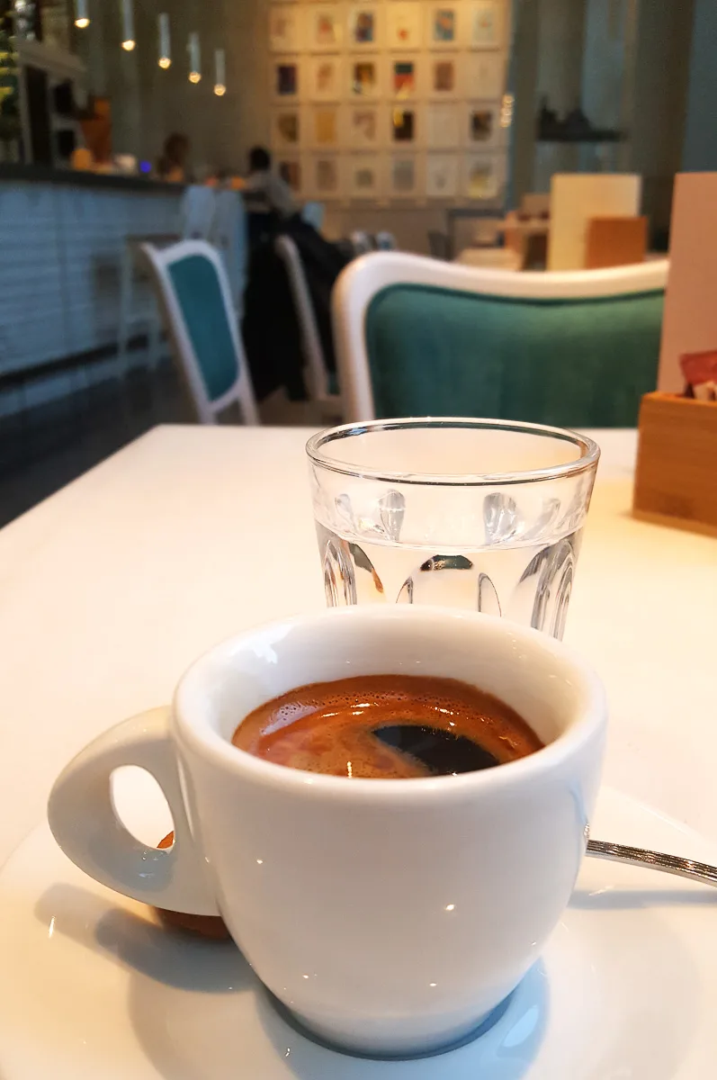 Espresso served with a glass of water - Vicenza, Italy - rossiwrites.com