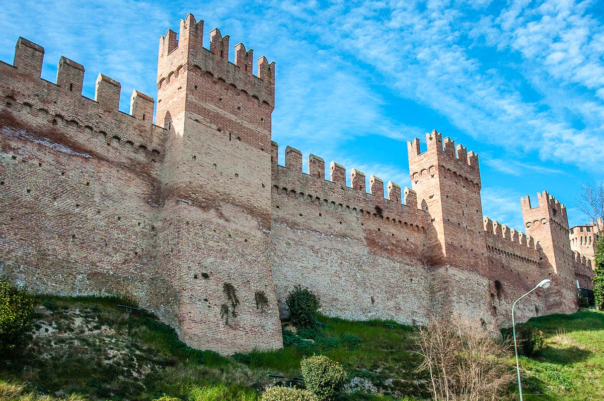 The mighty defensive wall surrounding the hilltop village - Gradara, Italy - rossiwrites.com