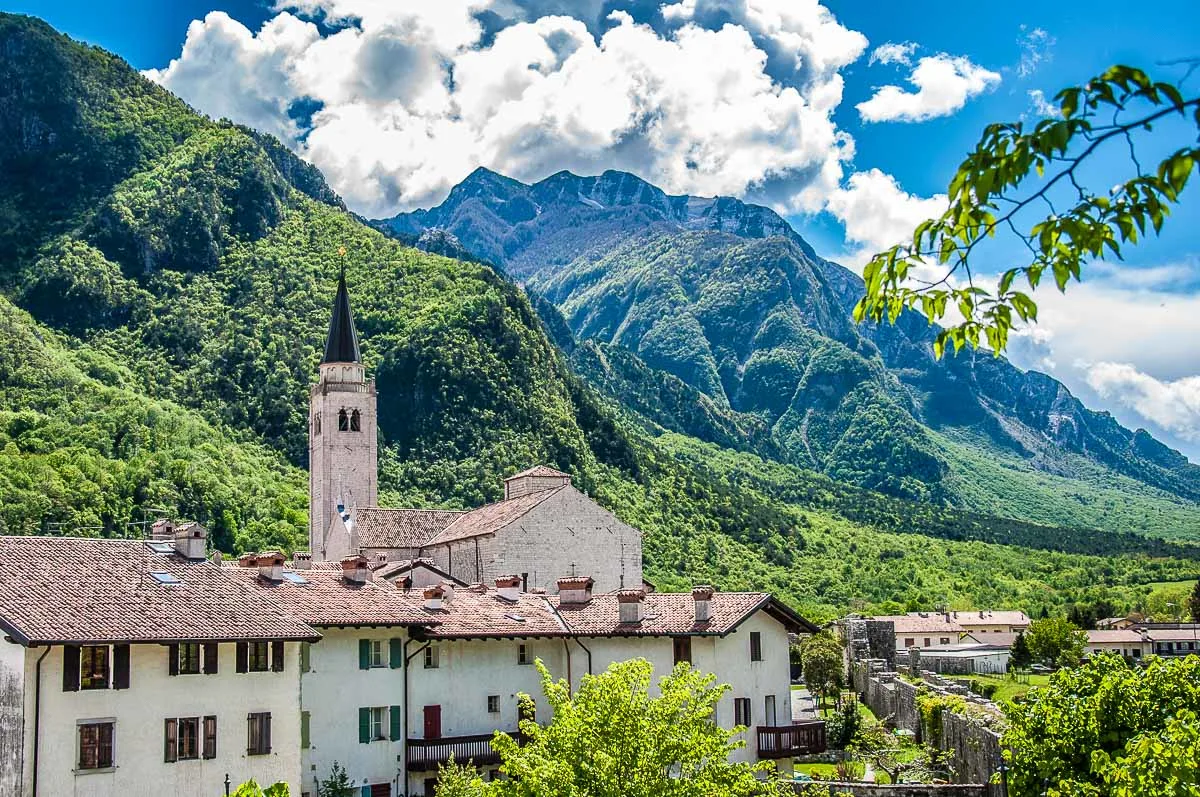 The village's bell tower with old houses around it - Venzone, Italy - rossiwrites.com